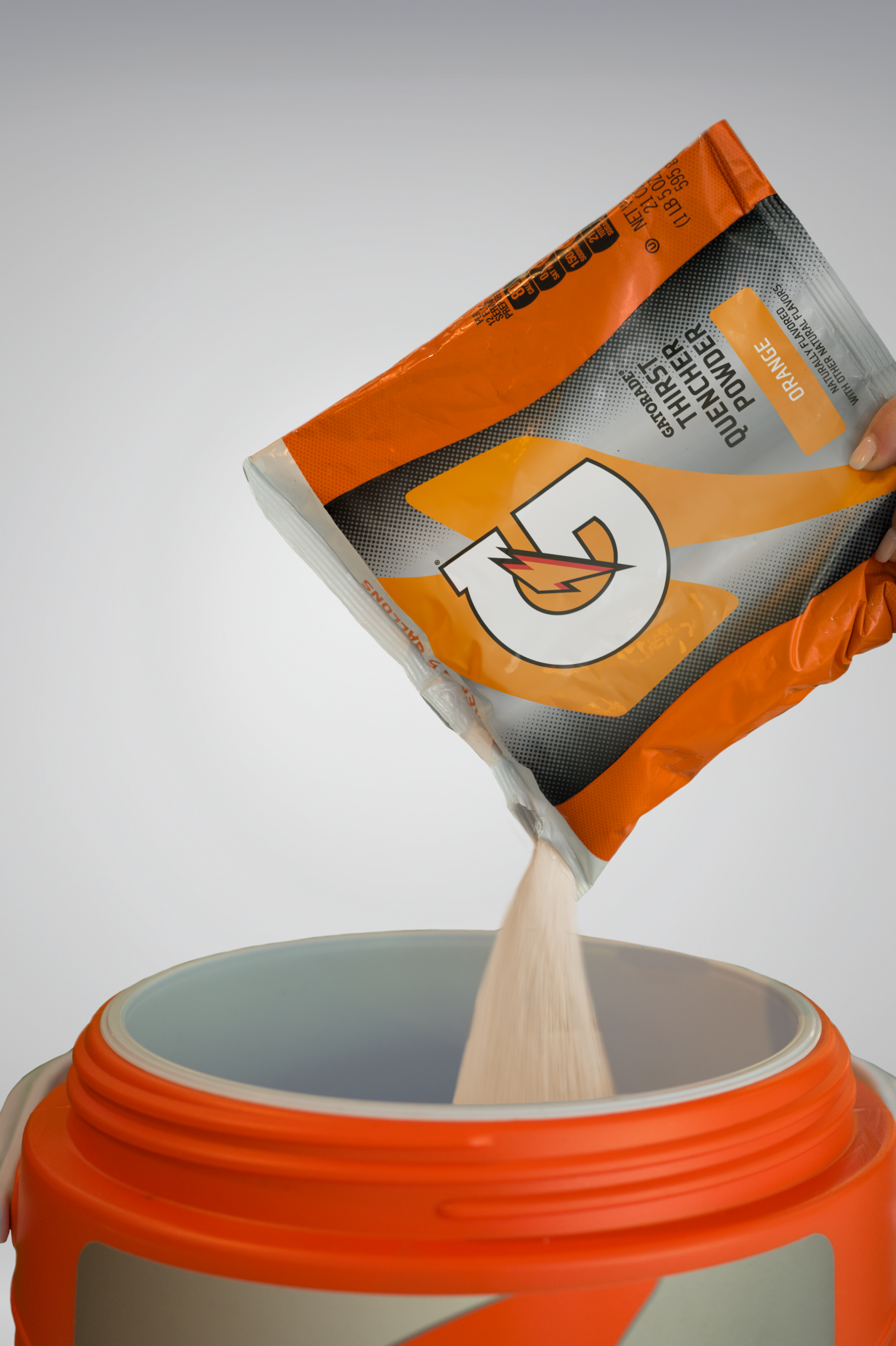 Gatorade powder poured into team cooler